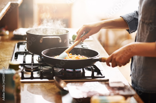 Cooking, kitchen and woman with food in a pan for lunch, dinner or supper in a modern house. Diet, wellness and closeup of a female person preparing a healthy meal in a pot on a stove at her home.