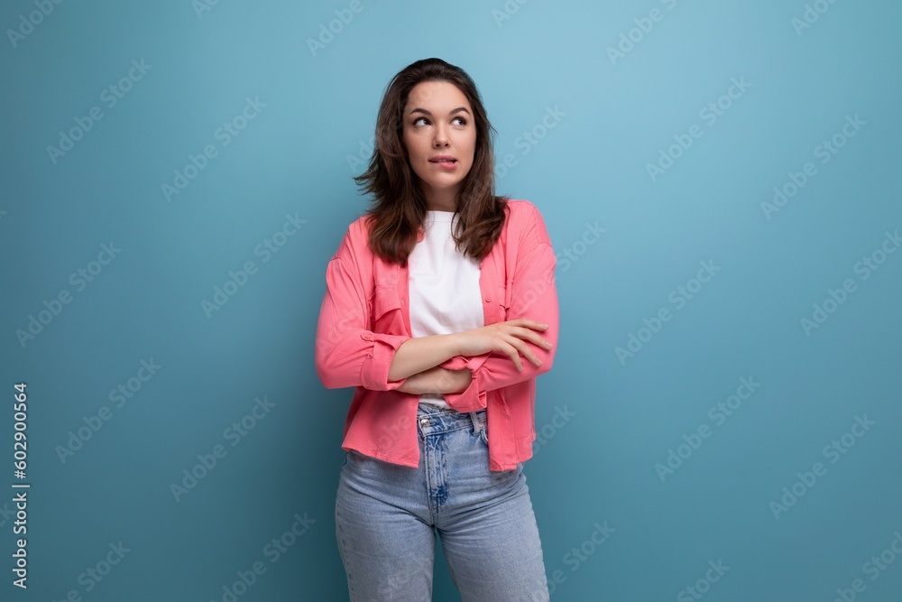 nice looking european brunette 30s woman in pink shirt with inspiration on studio background with copy space nice looking european brunette 30s woman in pink shirt with inspiration on studio background with copy space