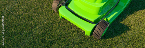 Fotografija Looking down onto a modern green electric lawn mower on a bright vibrant summers
