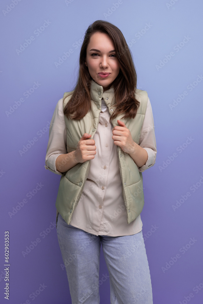 well-groomed caucasian brunette young lady in casual style on studio background well-groomed caucasian brunette young lady in casual style on studio background