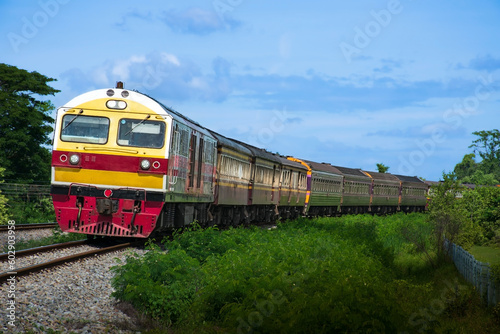 Passenger train by diesel locomotive passed the railway curve.