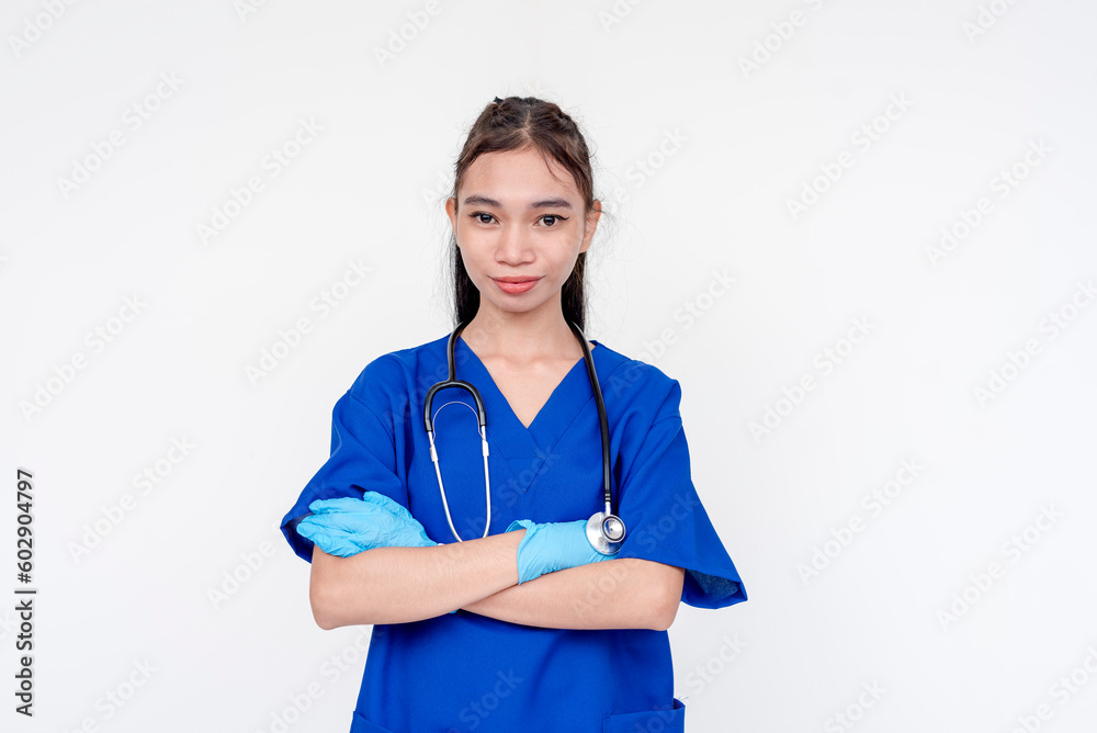 A joyful and smiling medical student or nurse or intern posing with her arms folded while wearing gloves. Isolated on a white background. A joyful and smiling medical student or nurse or intern posing with her arms folded while wearing gloves. Isolated on a white background.