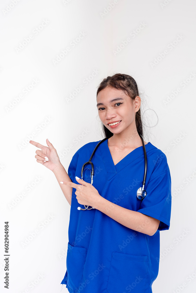 Portrait of a young and skilled medical student, nurse, intern posing and pointing to the right side with both hands. Isolated on a white background. Portrait of a young and skilled medical student, nurse, intern posing and pointing to the right side with both hands. Isolated on a white background.