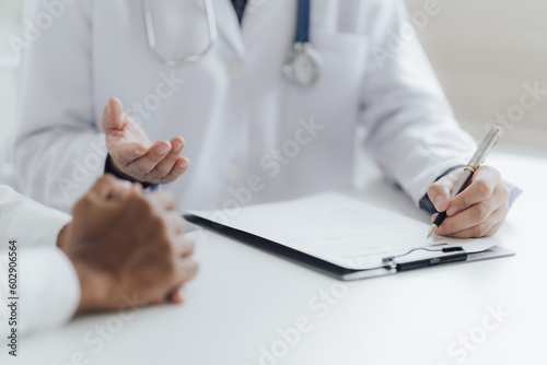 Close up view of professional physician consulting with male patient  talking to male client at medical checkup visit