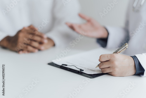 Close up view of professional physician consulting with male patient, talking to male client at medical checkup visit