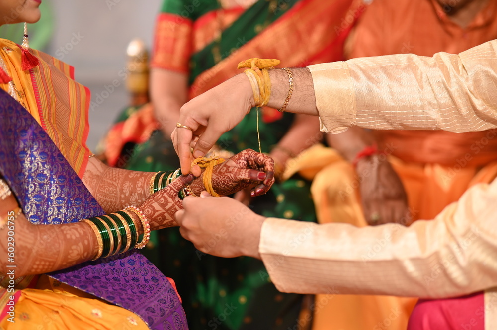 Kanyaadan Ceremony. Wearing Turmeric Thread on hand of bride. Marathi Wedding Ceremony