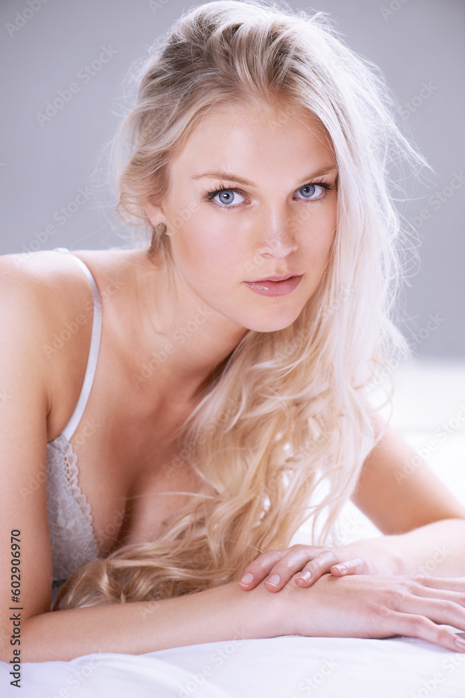 Beauty, lingerie and portrait of woman on bed for sensual, seductive makeup and attractive. Relax, cosmetics and glamour with face of female model in studio for desire, sensuality and elegant style