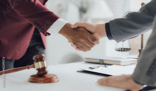 Businessman shaking hands to seal a deal with his partner lawyers or attorneys discussing a contract agreement.Legal law, advice, and justice concept	
