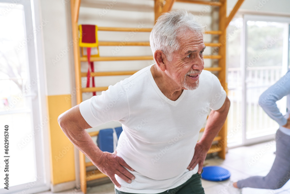 Smiling senior patients exercising at rehabilitation center Smiling senior patients exercising at rehabilitation center