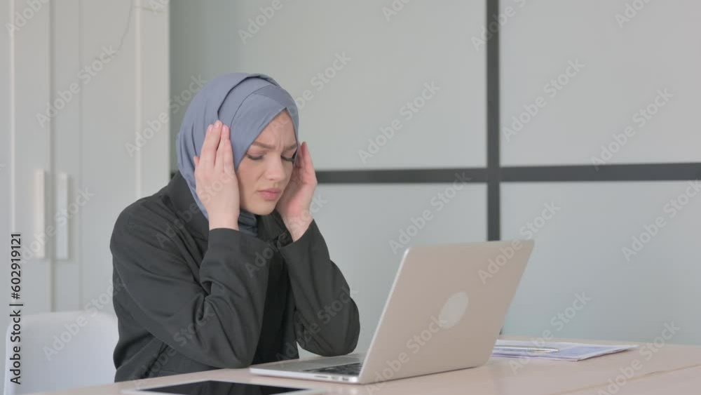 Muslim Businesswoman with Headache Working on Laptop Muslim Businesswoman with Headache Working on Laptop