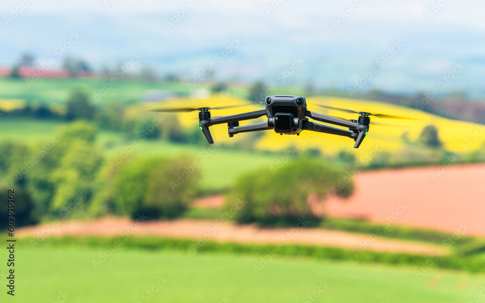 Drone in flight over fields and farms, Devon, England Drone in flight over fields and farms, Devon, England