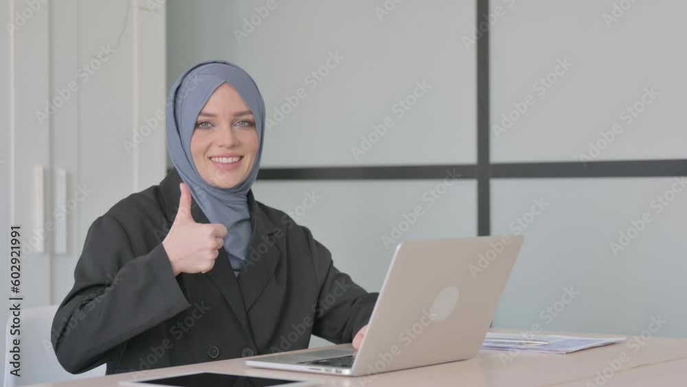 Thumbs Up by Muslim Businesswoman on Laptop Thumbs Up by Muslim Businesswoman on Laptop