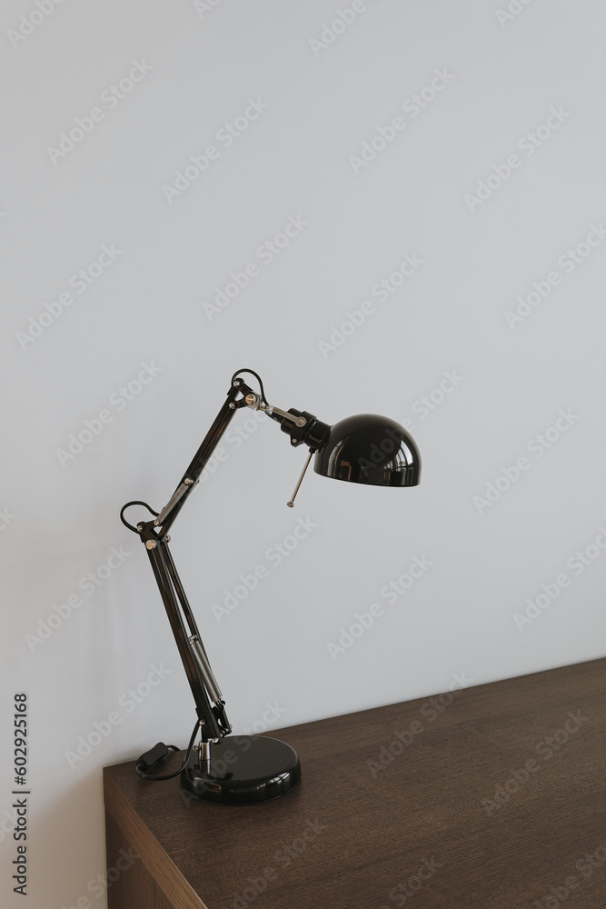 Lamp on wooden table near white wall Lamp on wooden table near white wall