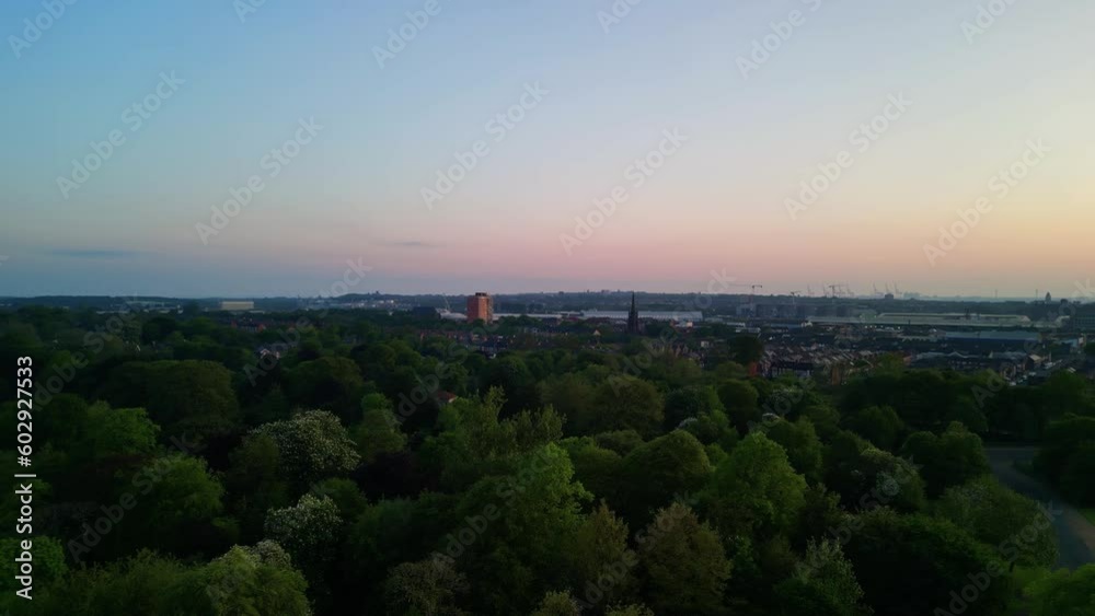 Birkenhead Park, upon which Central Park NY is based - Aerial drone at dawn, rise and pan right, Liverpool skyline yellow sun reveal - May 23 Birkenhead Park, upon which Central Park NY is based - Aerial drone at dawn, rise and pan right, Liverpool skyline yellow sun reveal - May 23