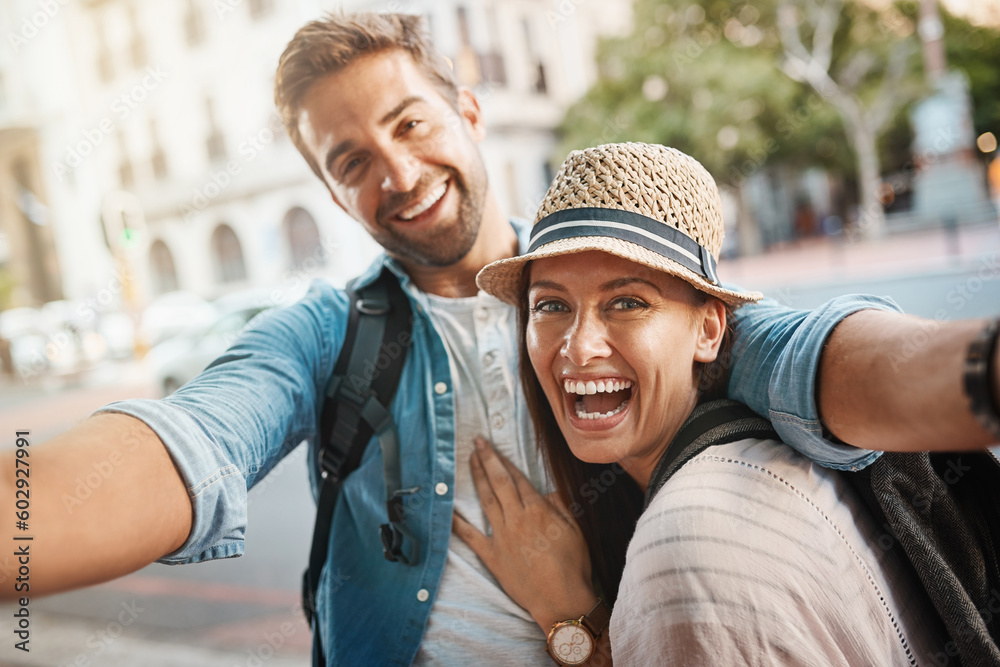 Tourist selfie, happy couple and outdoor for travel on a city street for happiness and holiday memory. Face of a man and a woman laughing on urban road for adventure, journey or vacation for freedom