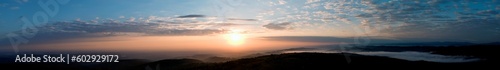 bright sunrise in the mountains with blue sky