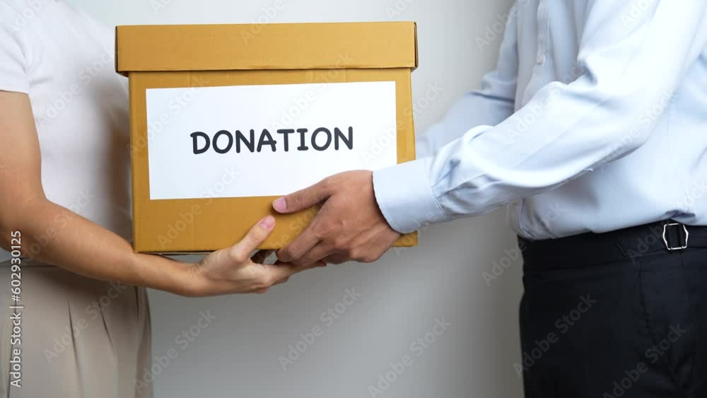 Donation, Charity, Volunteer, Giving and Delivery Concept. People donate Clothes and Food into Donation box at home or office for support and help poor, refugee and homeless people. Copy space Donation, Charity, Volunteer, Giving and Delivery Concept. People donate Clothes and Food into Donation box at home or office for support and help poor, refugee and homeless people. Copy space
