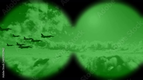 A squadron of unbranded military fighter jets flying through the night sky as viewed through night vision binoculars.