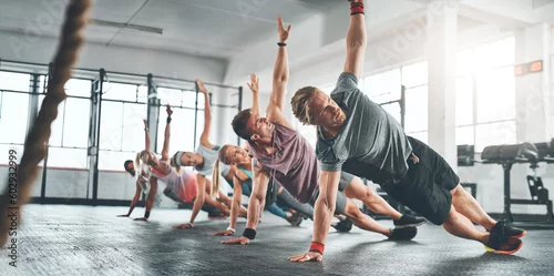Panel kuchenny z motywem Fitness class, group and people doing a workout in the gym for health, wellness and flexibility. Sports, training and athletes doing a side plank exercise challenge together in sport studio or center