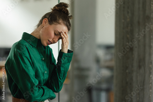 Young sad woman in office, having problem.