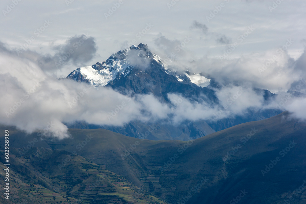 A view of a spectacular snow capped peak in the Andes Mountain range as seen from Maras in Peru. Maras is a town in the Sacred Valley of the Incas, 40 kilometers north of Cusco.
