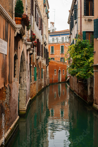 Cozy narrow canals of Venice city with old traditional architecture and bridges, Veneto, Italy. Tourism concept. Architecture and landmark of Venice. Cozy cityscape of Venice.