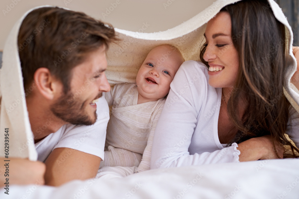 Happy mother, father and baby with blanket on bed for love, care and quality time together. Parents, family and playful newborn child relaxing in bedroom with bedding fort, smile and bonding at home Happy mother, father and baby with blanket on bed for love, care and quality time together. Parents, family and playful newborn child relaxing in bedroom with bedding fort, smile and bonding at home