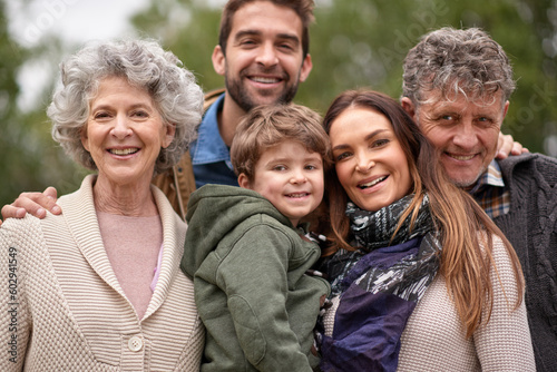 Family, grandparents and portrait of parents with kid in a park on outdoor vacation or holiday together. Face of old people, happiness and happy mother and father for love or care in nature