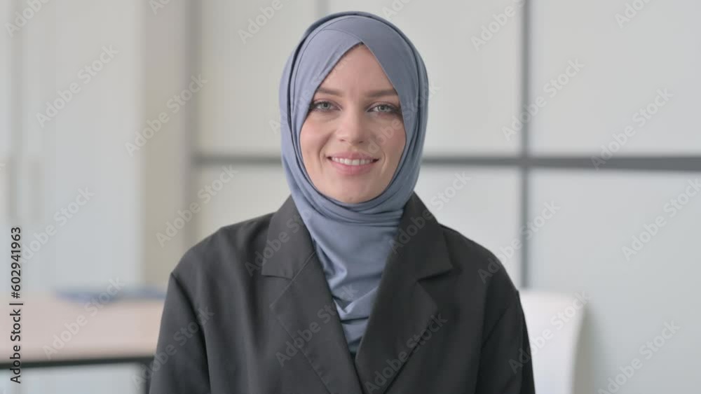 Portrait of Muslim Businesswoman Waving at Camera