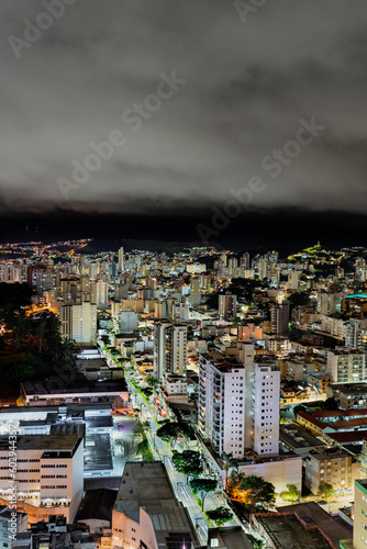 Night skyline of Brazilian city with illuminated skyscrapers and vehicle lights