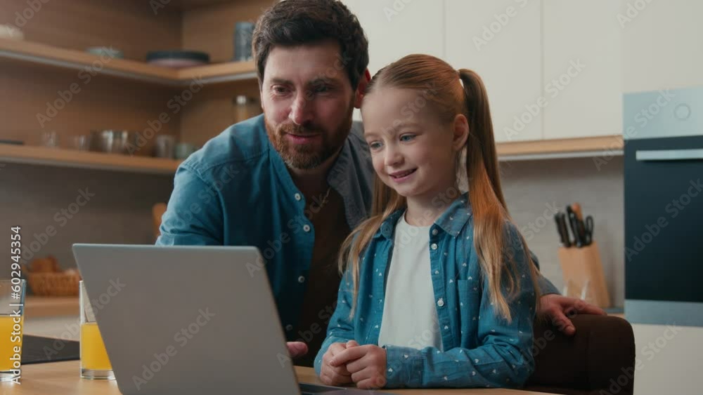 Caring father dad help daughter child girl with online task teaching little daughter using laptop app software educational service at home kitchen explain computer e-learning online child happy family