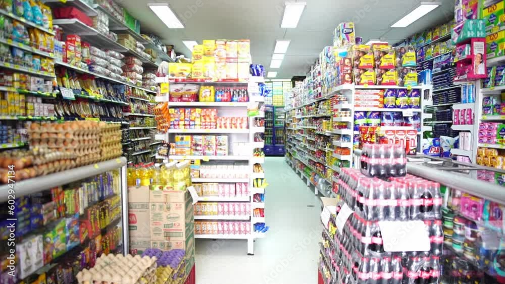 Fixed clip of full grocery store shelves, filled with brightly coloured products Fixed clip of full grocery store shelves, filled with brightly coloured products