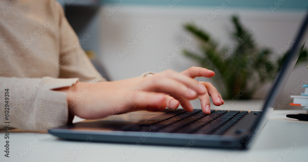 Close up hands of little girl typing on keyboard laptop. Schoolgirl typing on laptop keyboard, e-learning online communication. Kid use computer for education does homework, online education Close up hands of little girl typing on keyboard laptop. Schoolgirl typing on laptop keyboard, e-learning online communication. Kid use computer for education does homework, online education