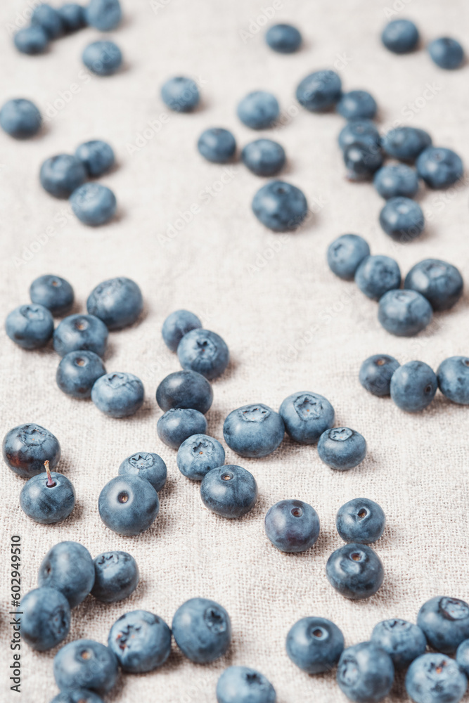 Fresh blueberries scattered on a linen napkin. Fresh blueberries scattered on a linen napkin.