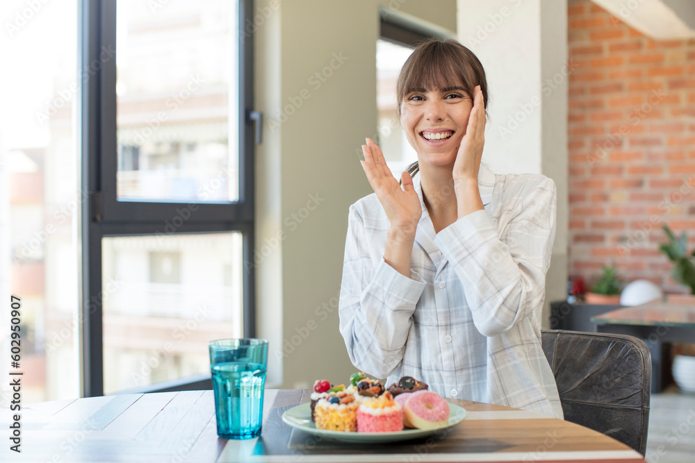 young pretty woman feeling happy and astonished at something unbelievable. home made cakes concept young pretty woman feeling happy and astonished at something unbelievable. home made cakes concept