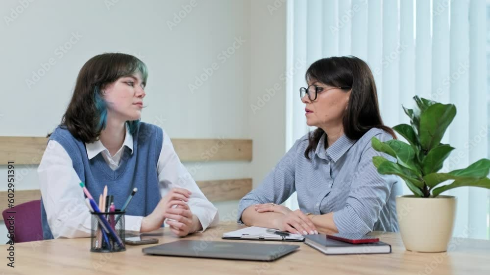 Sad girl student teenager at meeting with counselor, during therapy in college office Sad girl student teenager at meeting with counselor, during therapy in college office