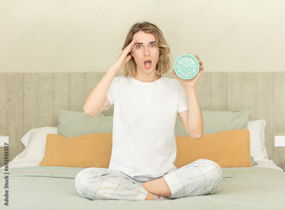 pretty woman looking happy, astonished and surprised alarm clock concept pretty woman looking happy, astonished and surprised alarm clock concept