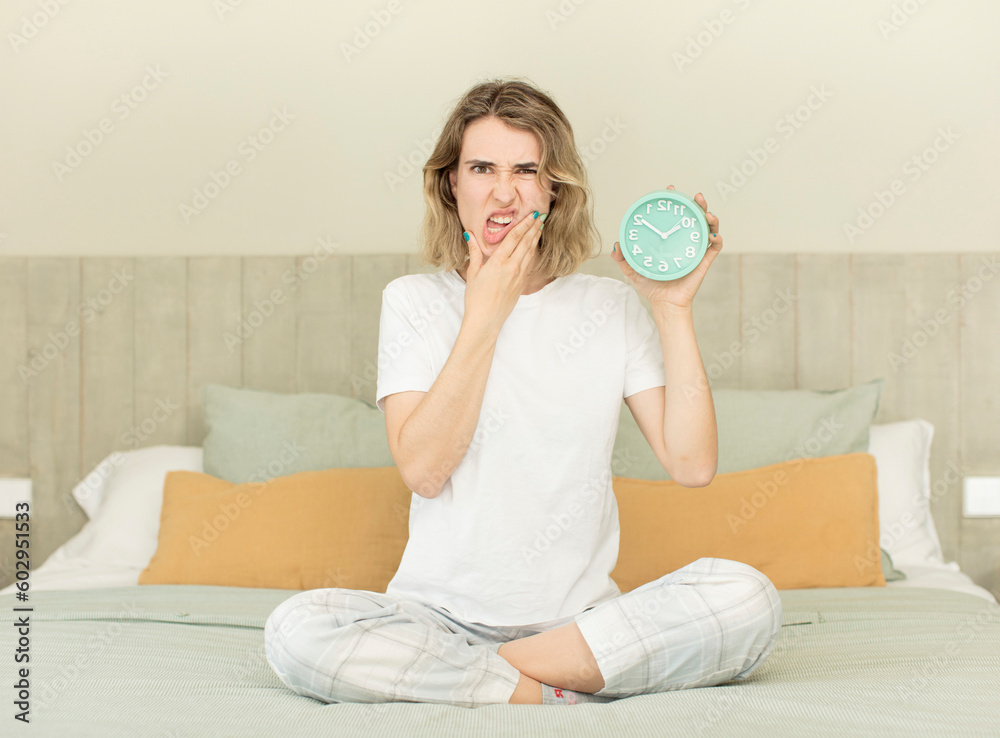 pretty woman with mouth and eyes wide open and hand on chin alarm clock concept pretty woman with mouth and eyes wide open and hand on chin alarm clock concept
