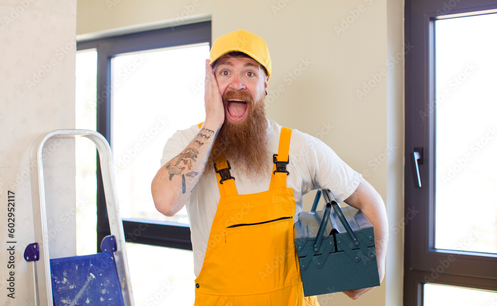 red hair man feeling happy and astonished at something unbelievable repairing home. handyman concept red hair man feeling happy and astonished at something unbelievable repairing home. handyman concept