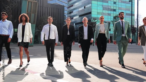 Slow motion of a big group or team of business people walking together with successful attitude in a modern workplace. Corporate startup employees colleagues on formal wear or suit with determination
