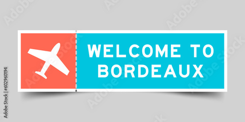 Orange and blue color ticket with plane icon and word welcome to bordeaux on gray background
