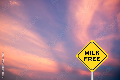 Yellow transportation sign with word milk free on violet color sky background