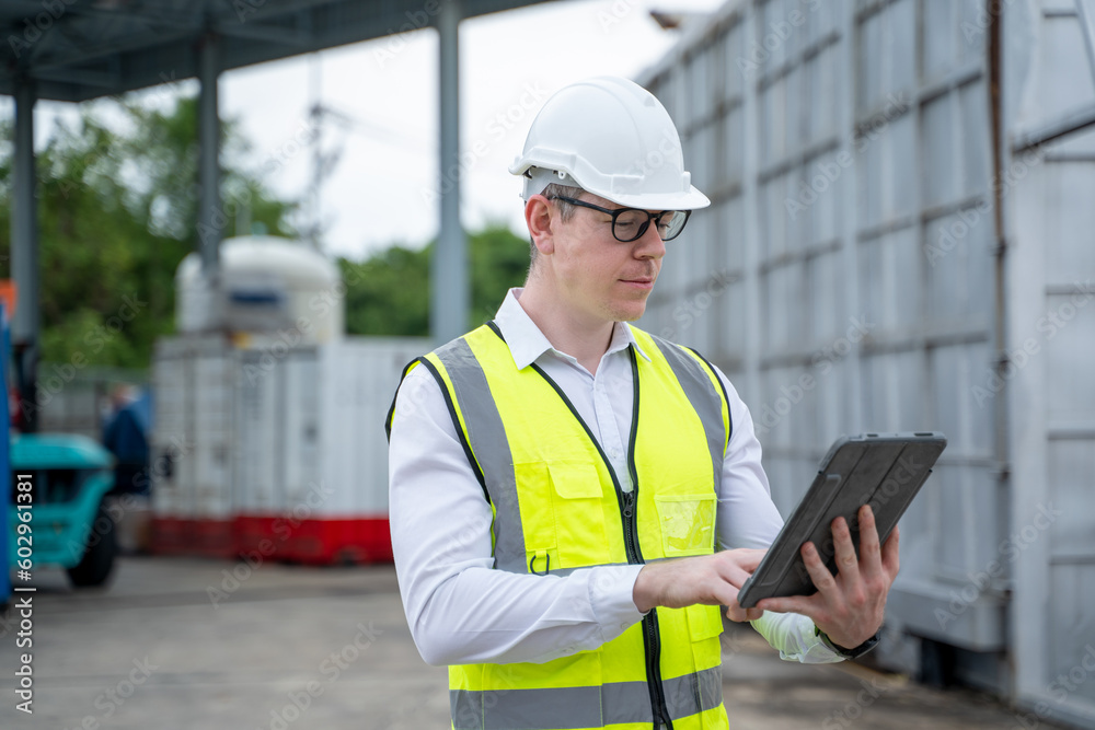 Industry Engineer wearing safety uniform checking on production in factory. Industry Engineer wearing safety uniform checking on production in factory.