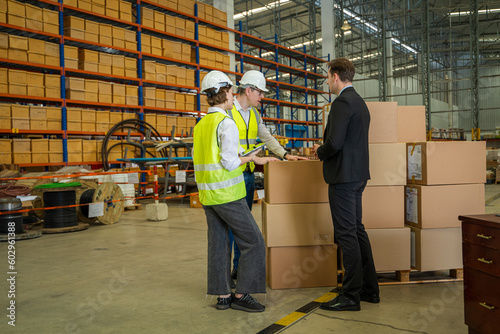 Warehouse managers and worker working together in warehouse office in a large distribution warehouse,Logistic industry concept.