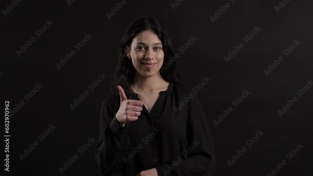 Happy Middle Aged Businesswoman Showing Thumbs Up in a Black Shirt on Black Background
Happy Middle Aged Businesswoman Showing Thumbs Up in a Black Shirt on Black Background