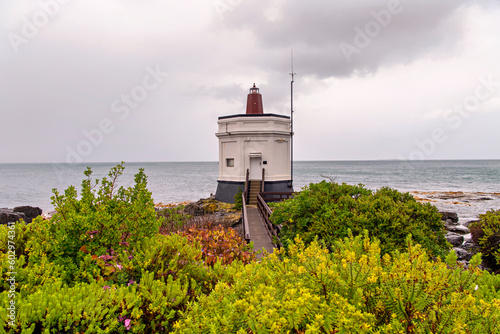 Stirling Point Lighthouse under cloudy sky, Bluff, New Zealand