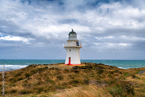 Waipapa Point lighthouse on the South Island of New Zealand in rough  stormy seas
