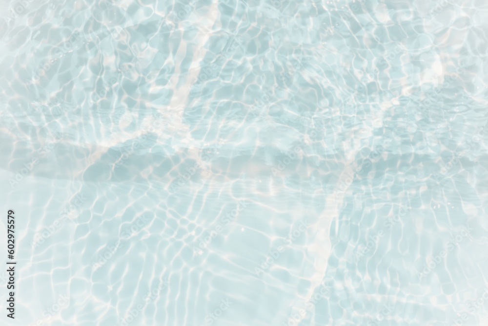 Obraz premium Blue water with ripples on the surface. Defocus blurred transparent blue colored clear calm water surface texture with splashes and bubbles. Water waves with shining pattern texture background.