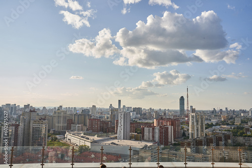 Against the background of a blue sky with clouds, a bird's-eye view of the millionaire city. The dense construction of the city is visible from above. High quality photo