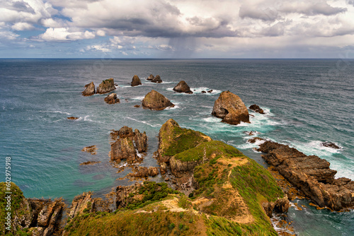 offshore rocks in the surf at Nugget Point Ligthouse, Otage New Zealand photo